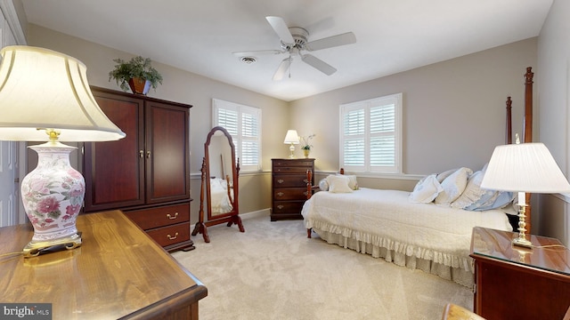 bedroom featuring light carpet and ceiling fan