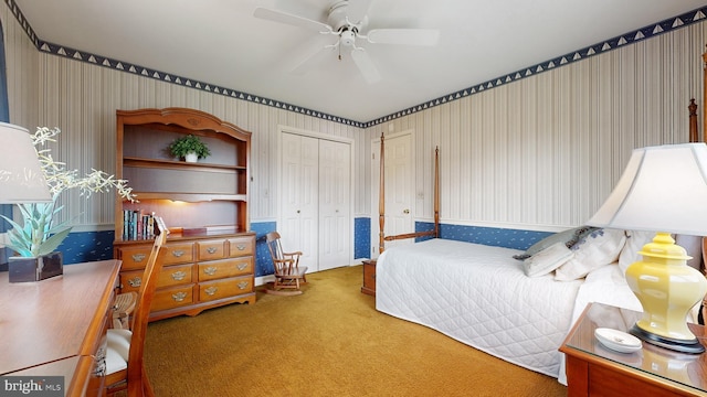 carpeted bedroom with a closet and ceiling fan