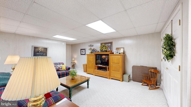 carpeted living room featuring a paneled ceiling