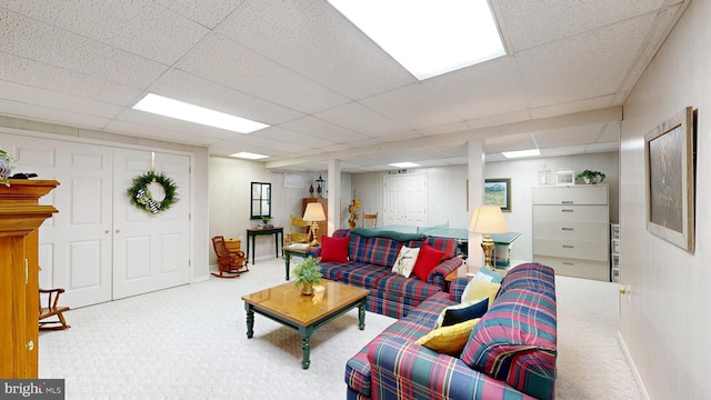 living room with a paneled ceiling