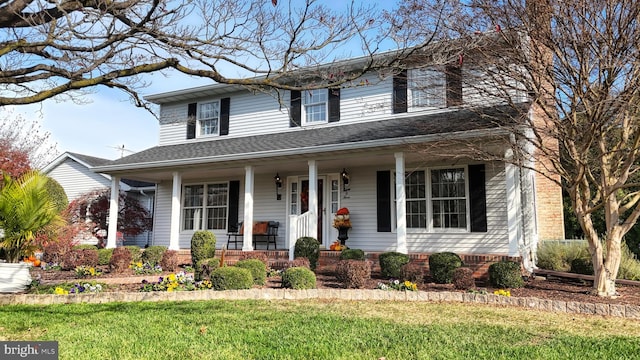 view of front facade with a porch and a front yard