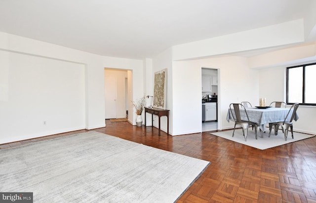 dining space featuring dark parquet floors