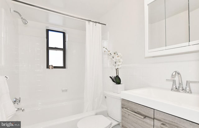 full bathroom featuring toilet, tile walls, vanity, and shower / tub combo with curtain