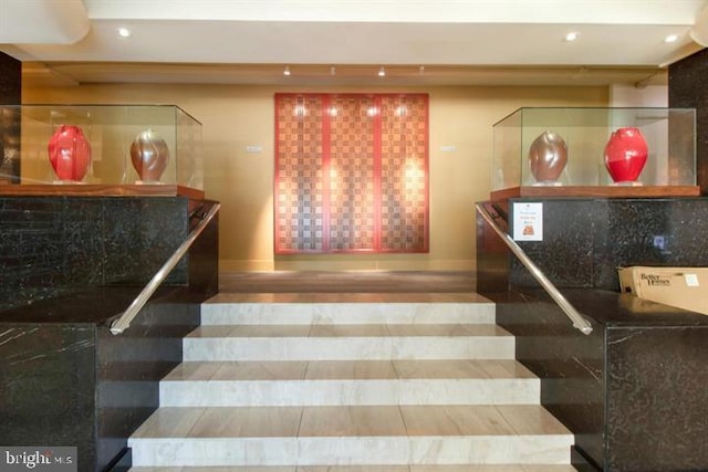 stairway featuring hardwood / wood-style floors