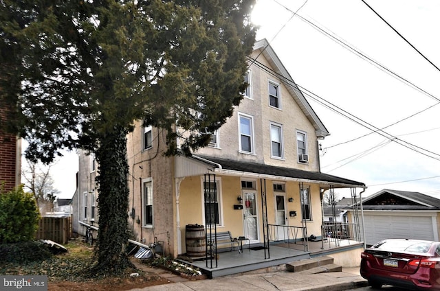 view of front of home with a porch and a garage