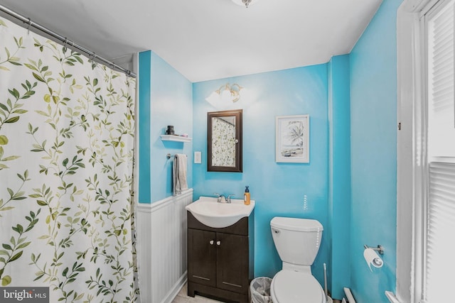 bathroom featuring walk in shower, vanity, and toilet