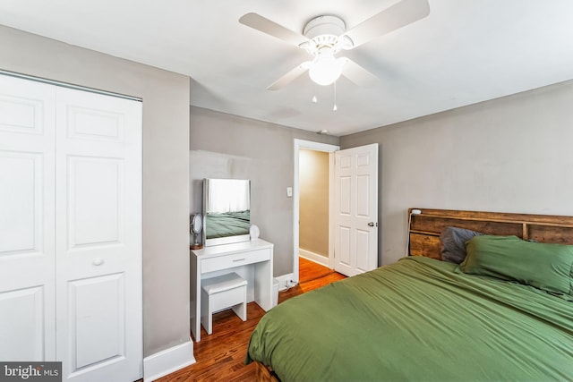 bedroom featuring ceiling fan, a closet, and wood-type flooring