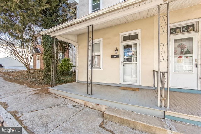 view of exterior entry with a porch