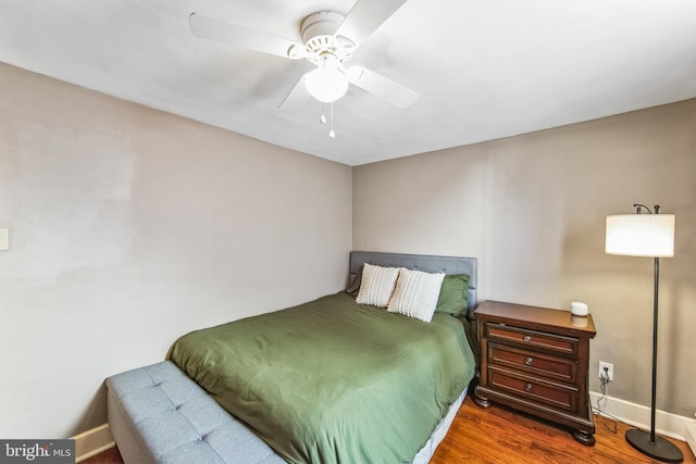 bedroom with ceiling fan and dark hardwood / wood-style floors