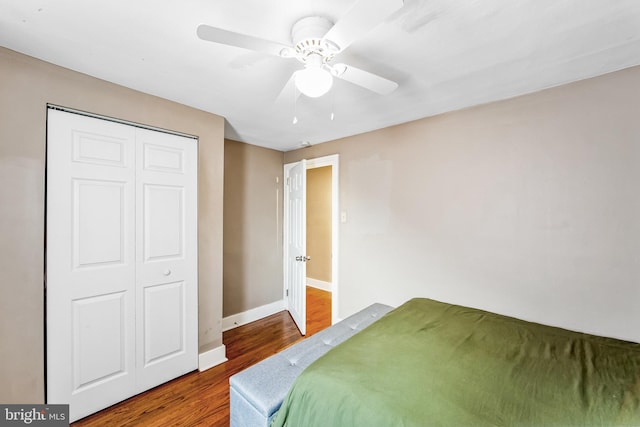 bedroom with hardwood / wood-style floors, a closet, and ceiling fan