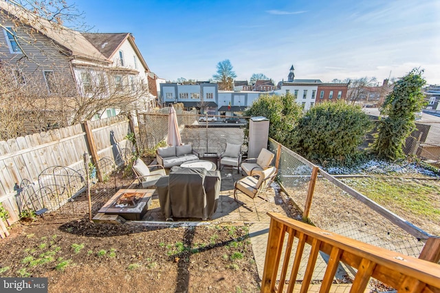 view of yard featuring a patio area and an outdoor living space with a fire pit