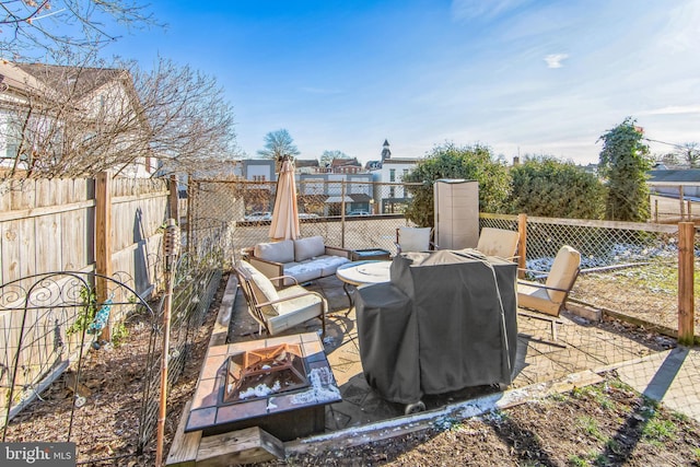 view of patio / terrace featuring a grill and an outdoor living space with a fire pit