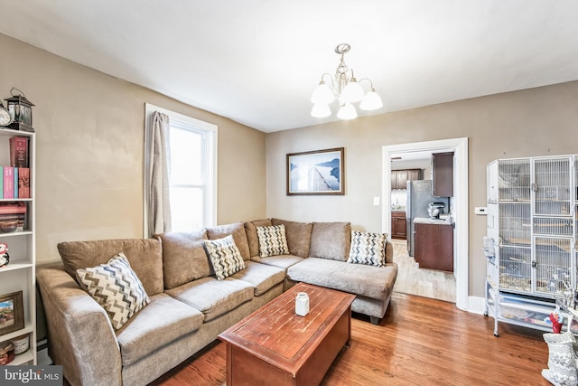 living room with hardwood / wood-style flooring and a notable chandelier