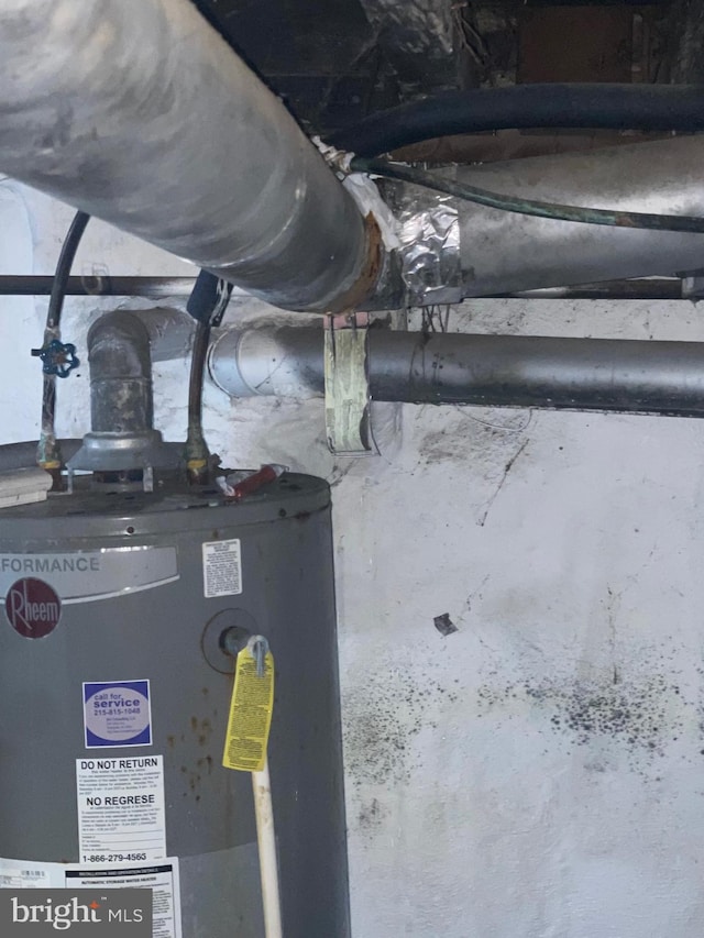 utility room featuring water heater