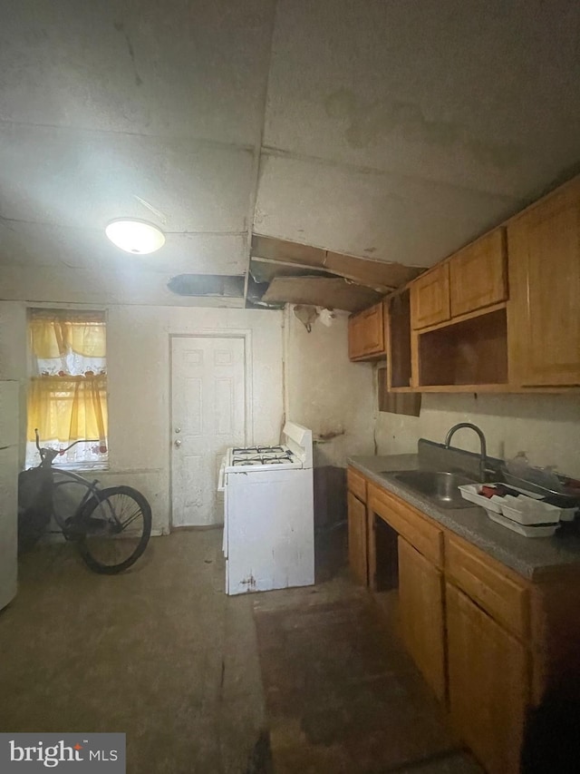 kitchen featuring washer / dryer and sink