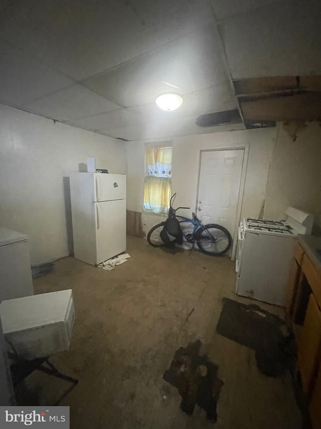 basement with washer / dryer and white refrigerator