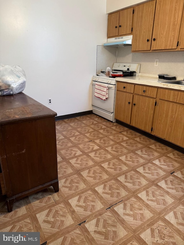 kitchen featuring sink, light parquet floors, and white range