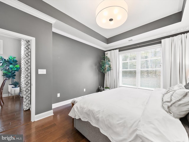 bedroom featuring dark hardwood / wood-style floors and crown molding