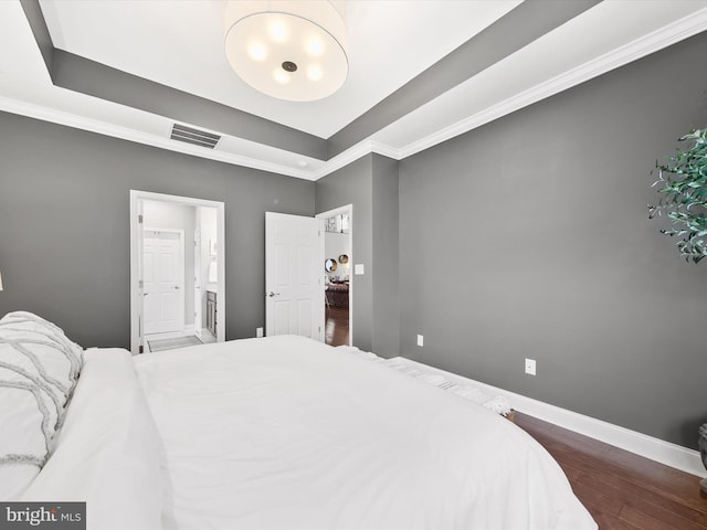 bedroom featuring crown molding and dark hardwood / wood-style floors