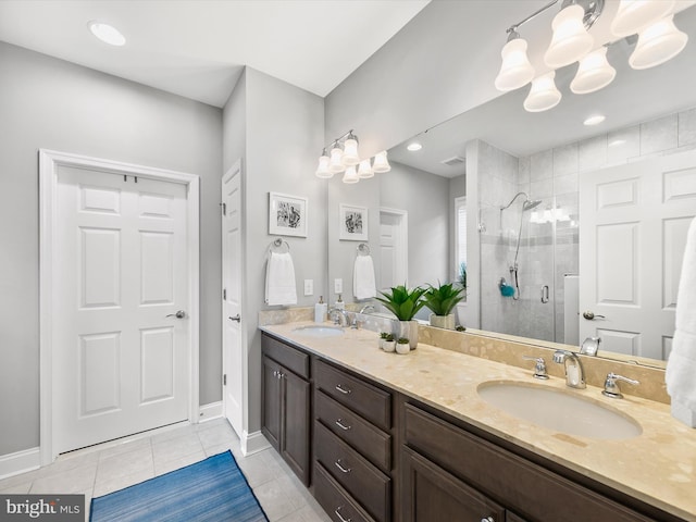 bathroom featuring tile patterned floors, vanity, walk in shower, and a chandelier