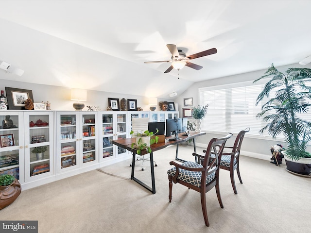 office space with light carpet, ceiling fan, and vaulted ceiling