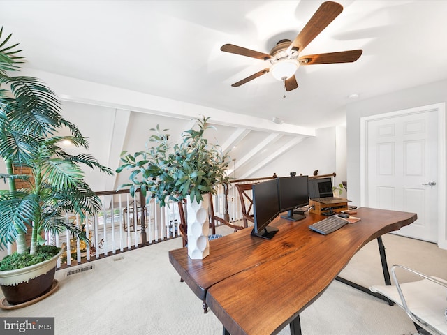 carpeted home office featuring vaulted ceiling with beams and ceiling fan