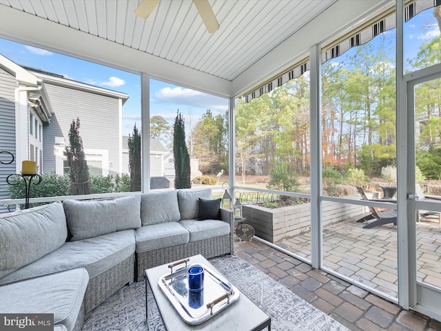 sunroom / solarium featuring ceiling fan