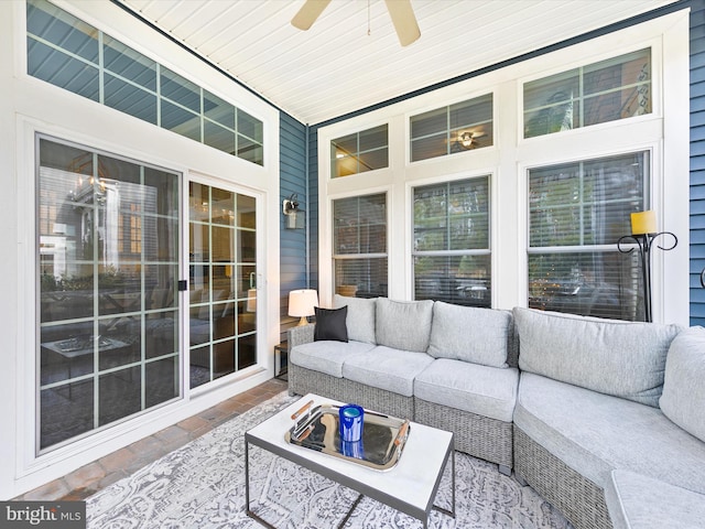 sunroom featuring ceiling fan and wood ceiling