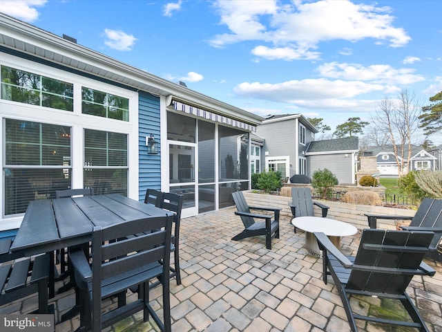 view of patio / terrace featuring a sunroom