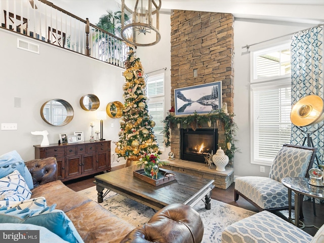 living room with hardwood / wood-style floors, plenty of natural light, and high vaulted ceiling