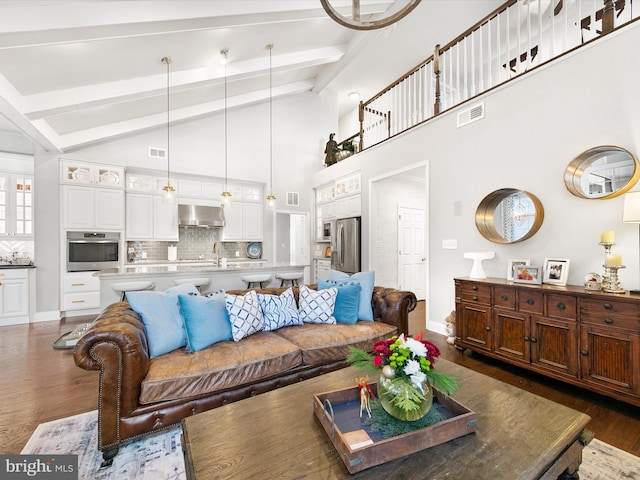 living room with beam ceiling, sink, high vaulted ceiling, and dark hardwood / wood-style floors