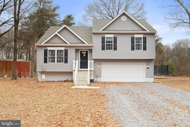 view of front of home featuring a trampoline and a garage