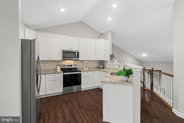 kitchen featuring kitchen peninsula, appliances with stainless steel finishes, sink, white cabinets, and dark hardwood / wood-style floors