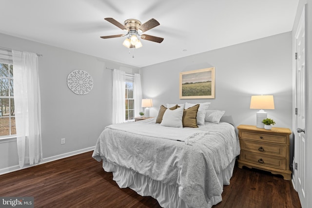 bedroom with ceiling fan and dark hardwood / wood-style floors