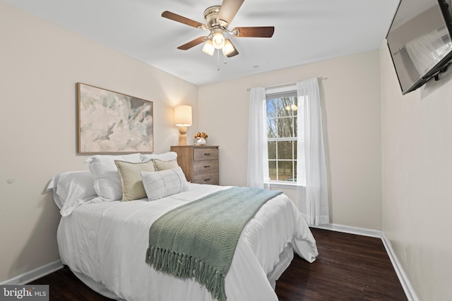 bedroom with ceiling fan and dark hardwood / wood-style flooring