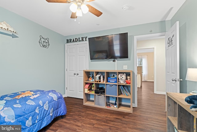 bedroom with dark hardwood / wood-style flooring and ceiling fan