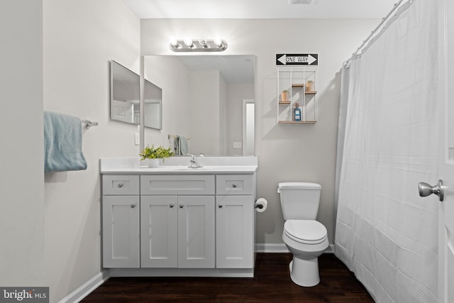 bathroom featuring hardwood / wood-style flooring, vanity, and toilet