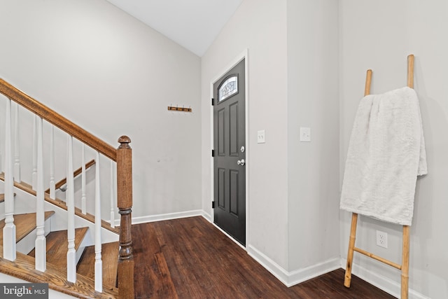 foyer with dark hardwood / wood-style floors and vaulted ceiling