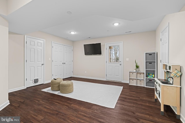 interior space with dark hardwood / wood-style flooring and sink