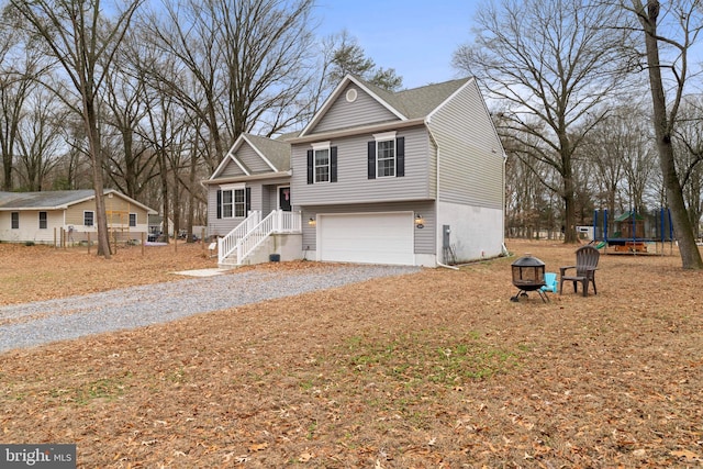 view of front of house with a garage and a trampoline