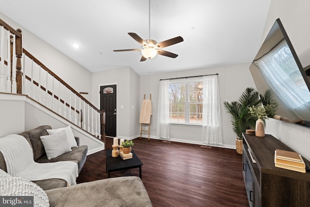 living room with ceiling fan and dark wood-type flooring