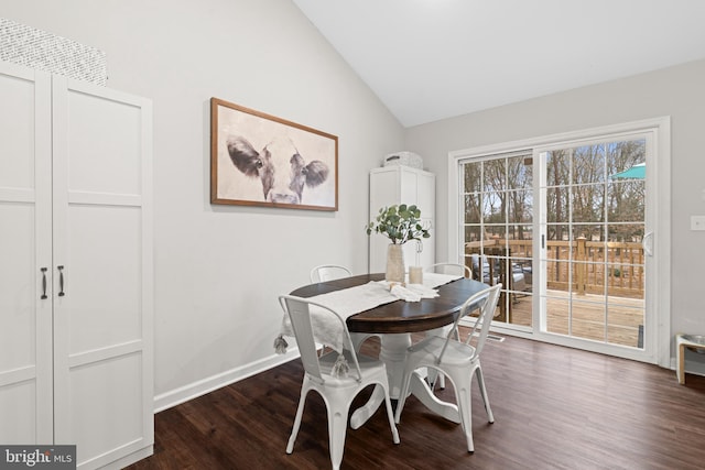 dining area with dark hardwood / wood-style flooring and lofted ceiling