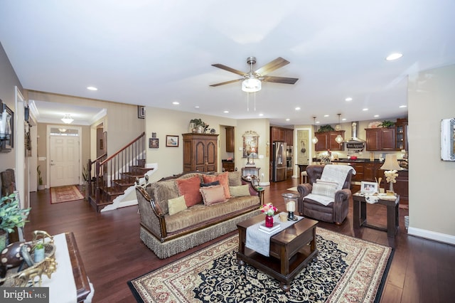 living room featuring ceiling fan and dark hardwood / wood-style flooring