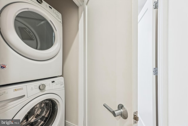 washroom with stacked washing maching and dryer