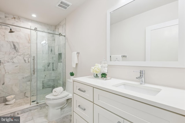 bathroom with an enclosed shower, vanity, and toilet