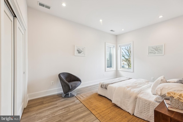 bedroom featuring light wood-type flooring and a closet