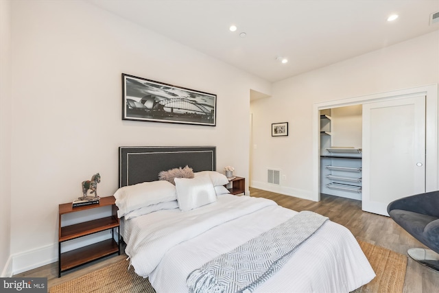 bedroom with hardwood / wood-style floors and a closet