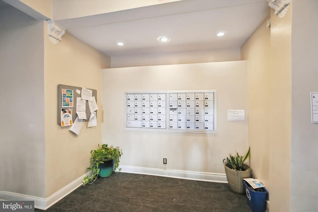 clothes washing area with mail boxes and dark carpet