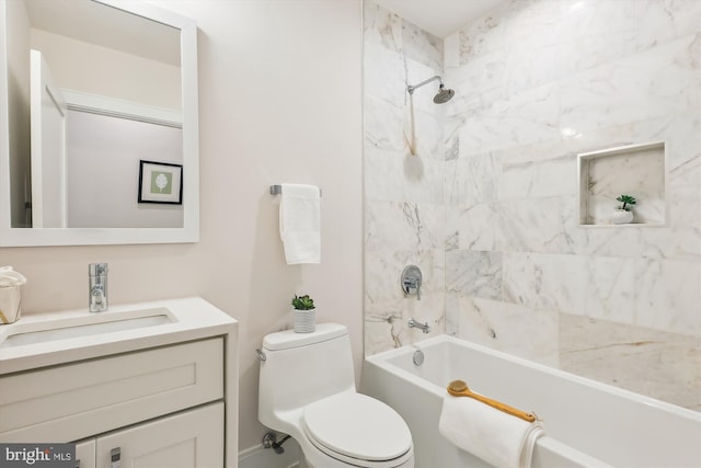 full bathroom with vanity, tiled shower / bath combo, and toilet