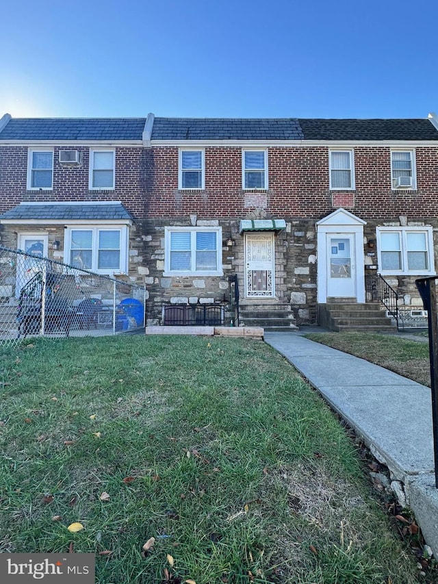 view of property featuring a front lawn